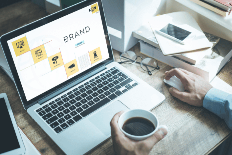 A person working on a laptop, focused on the concept of his personal brand